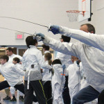 A student lunges during adult classes at Tidewater Fencing Club.