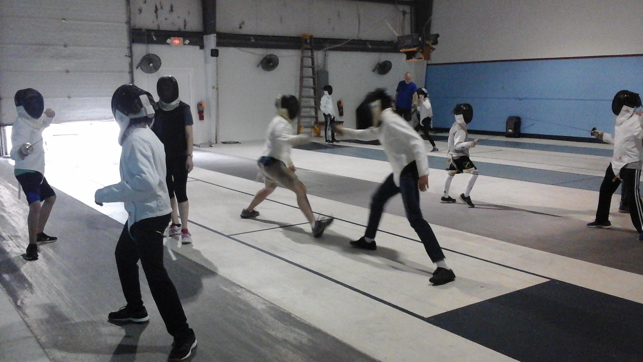 Fencers practicing skills in an Intermediate Class.