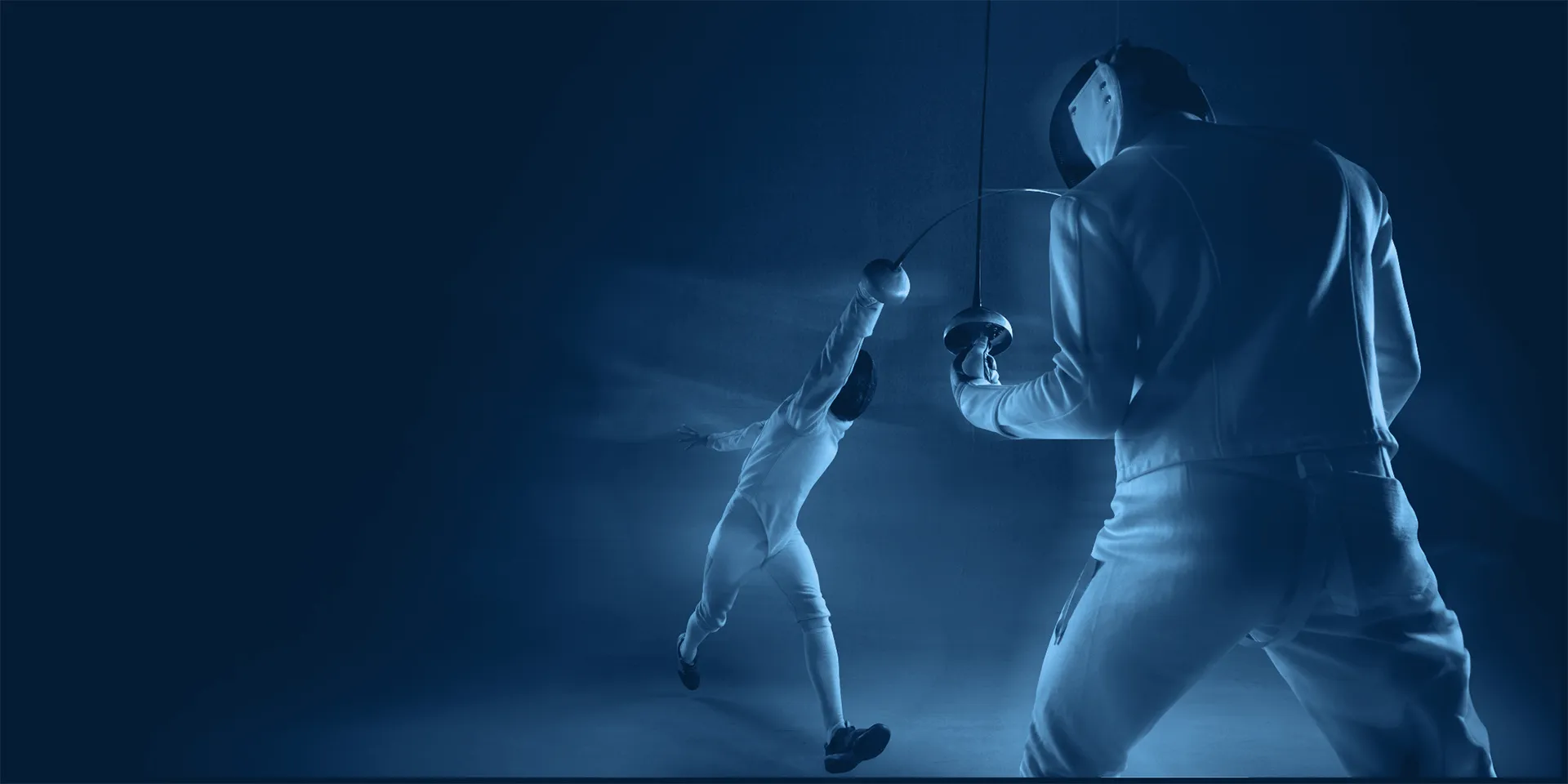 An epee fencer fleches at his opponent, catching him by surprise. The whole photo is in monochromatic blue.